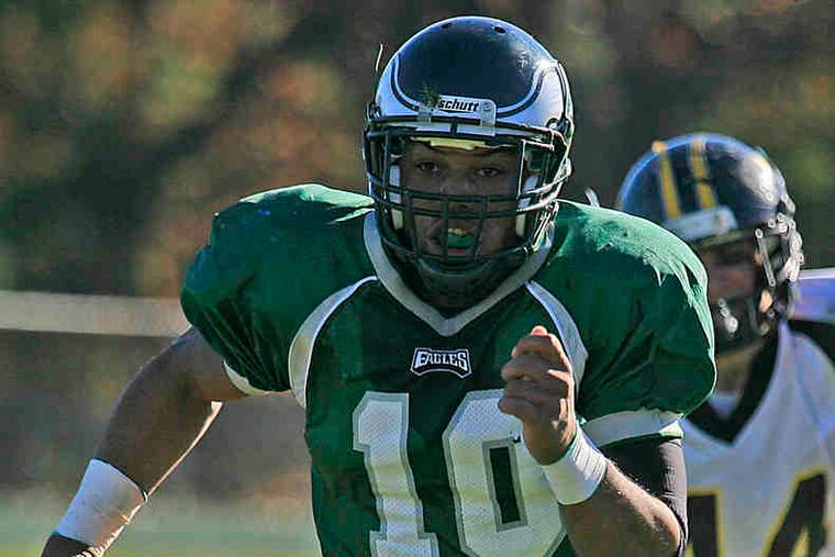 Winslow Township QB Bill Belton takes off on a 20-yard run to score the Eagles' first TD in the first quarter. Belton had two touchdowns rushing and three passing to lead the attack.