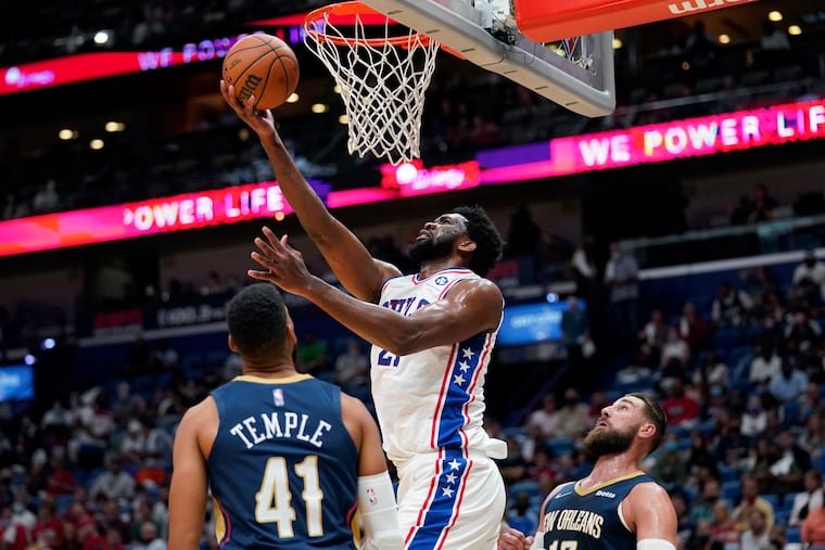 Sixers center Joel Embiid goes to the basket over Pelicans forward Garrett Temple on Wednesday, Oct. 20, 2021 in New Orleans.
