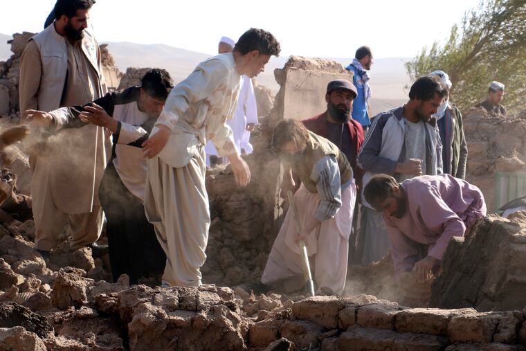 Afghan men search for victims after an earthquake in Zenda Jan district in Herat province, of western Afghanistan, Sunday. Powerful earthquakes killed at least 2,000 people in western Afghanistan, a Taliban government spokesman said Sunday. It's one of the deadliest earthquakes to strike the country in two decades.