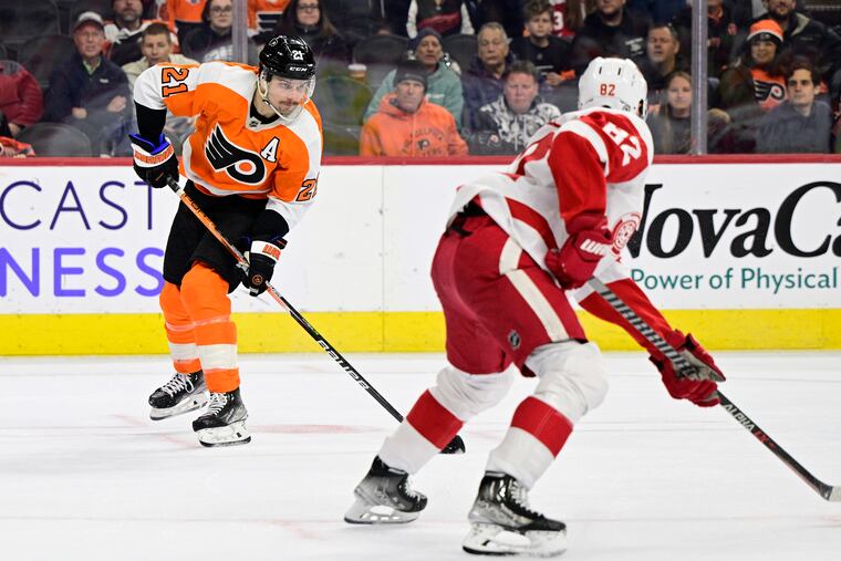 Scott Laughton (left) takes a shot past Jordan Oesterle (82) during the second period on Saturday. Laughton had a goal and an assist.