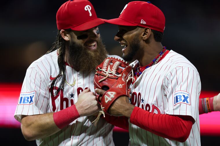 Philadelphia Phillies left fielder Brandon Marsh and center fielder Johan Rojas share a laugh after a pair of outfield catches during the fifth inning of the Philadelphia Phillies game against the Chicago Cubs at Citizens Bank Park on Monday.