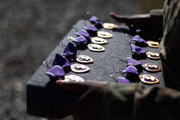 A military aide holds Purple Heart medals that U.S. Sec. of Defense Leon Panetta will award during his visit to the 172nd Infantry Brigade Task Force Blackhawks at a forward operating base in Sharana, Afghanistan,Wednesday, Dec., 14, 2011. (AP Photo/Pablo Martinez Monsivais, Pool)