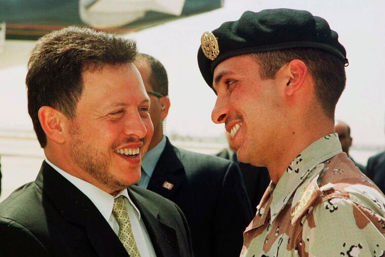 In this 2001 file photo, Jordan’s King Abdullah II laughs with his half brother Prince Hamzah, right, shortly before the monarch embarked on a tour of the United States. A new audio recording that circulated online Tuesday, seems to capture an explosive meeting between Prince Hamzah and the army chief of staff that triggered a rare public rift at the highest levels of the royal family.