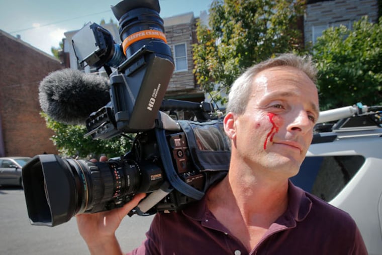 Cops say Bryan Zilai, cameraman for Fox 29, was assaulted while covering the story regarding bodies found in a garage. (ALEJANDRO A. ALVAREZ / STAFF PHOTOGRAPHER)
