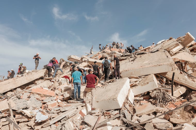 People look for survivors in the ruins of a residential building that collapsed amid earthquakes in La Guaira, Venezuela, June 25, 2026. Experts pointed to several indications that the twin earthquakes were particularly lethal, including the number of people reported missing and the extent of building damage.