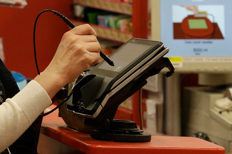 A woman pays by credit card at a retail store in California in this 2013 file photo.