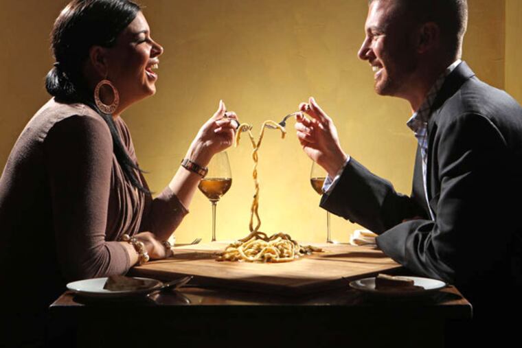 Playing Lady and the Tramp, Caitlin Keyser and Kyle Stoudnour share the rustically romantic 30-foot pasta alla mugnaia noodles at Le Virtu. (MICHAEL BRYANT / Staff Photographer)