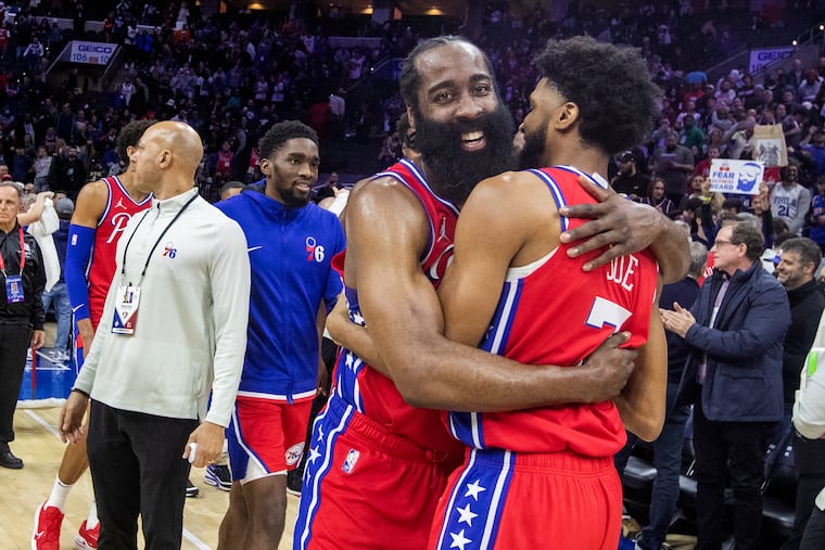 James Harden, center, of the Sixers hugs Isaiah Joe after their victory over the Knicks at the Wells Fargo Center on March 2, 2022.