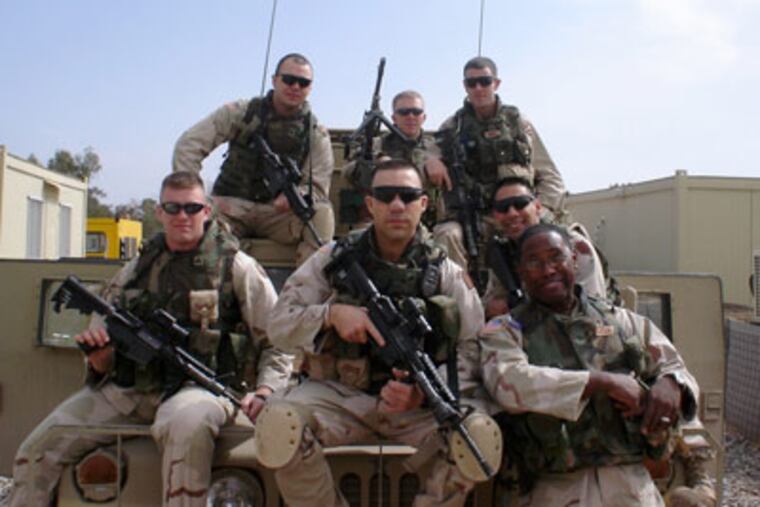 Portrait of (clockwise from front center) Gennaro Pellegrini, Mark Fisher, Francis J. Straub, Dan South, Sean M. Snell, John Kulick and Robert Jackson in Iraq. (David Swanson/ Staff)