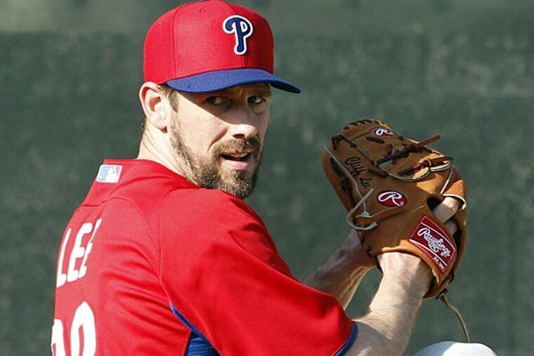 Phillies' pitcher Cliff Lee winds-up with the baseball during workouts at Bright House Field in Clearwater, FL on Monday, February 11, 2013. (Yong Kim/Staff Photographer)