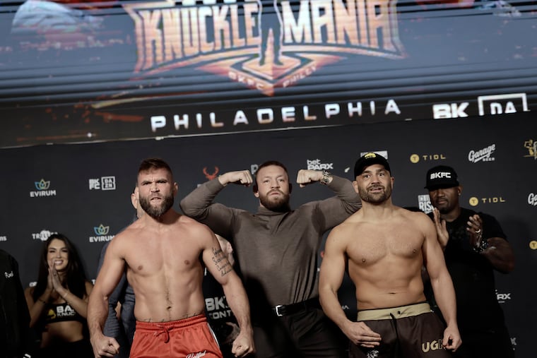 Jeremy Stephens (from left), Conor McGregor, and Eddie Alvarez flex during the Bare Knuckle Fighting Championship weigh-ins on Friday at Xfinity Live! in South Philadelphia. Alvarez and Stephens will face off in the main event Saturday night at the Wells Fargo Center.