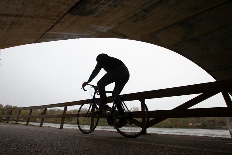 A cyclist out for a ride on the Schuylkill River trail on Friday.
