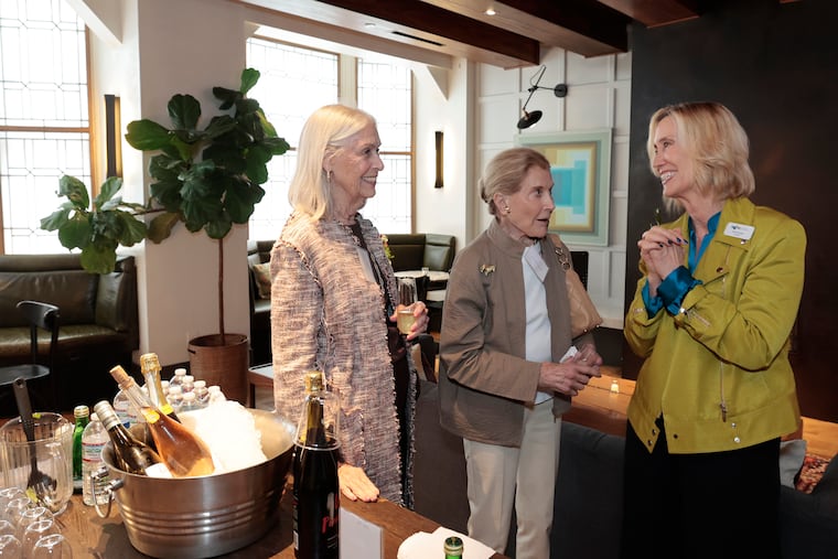 Moore College of Art & Design President Cathy Young (right) talks with Board of Trustees chair Frances R. Graham (left) and chair emerita and trustees member Cissie Levy at the opening ceremony of Rittenhouse Hall, a new residence hall for Moore students at 1831 Chestnut Street in Center City.