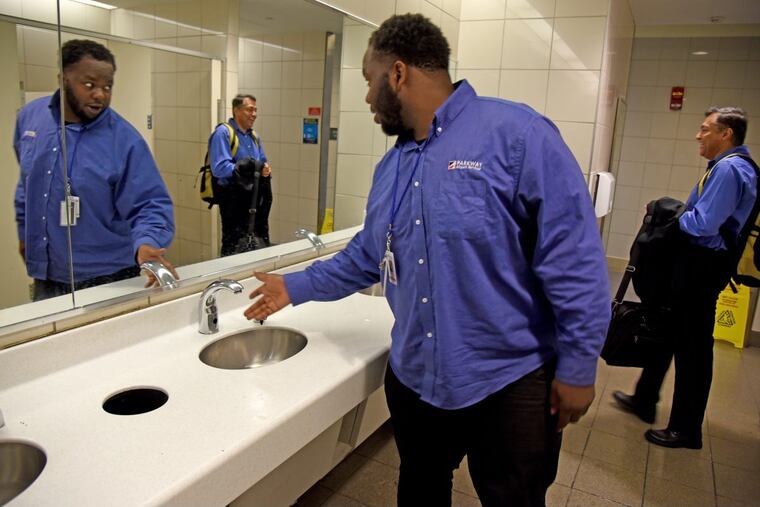 C.J. Mariney, of North Philadelphia, who works with Parkway at Philadelphia International Airport, checks on water pressure – finding none – in the restroom May 7, 2018 after a water main break under the parking lot shut down the water to all terminals.