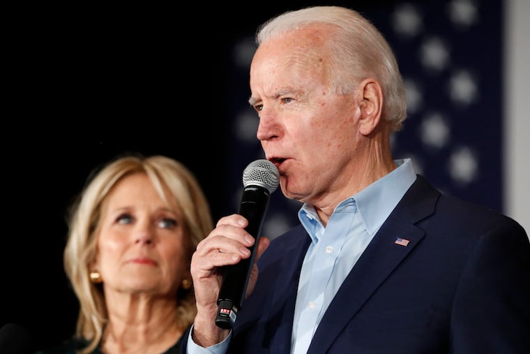 Democratic presidential candidate former Vice President Joe Biden speaks with Jill Biden at a caucus night campaign rally on Monday, Feb. 3, 2020, in Des Moines, Iowa.