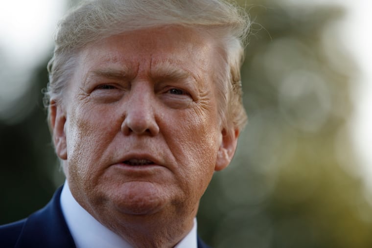 President Donald Trump pauses as he talks to media before boarding Maine One at the White House in Washington, Friday, Aug. 30, 2019, en route to Camp David in Maryland.