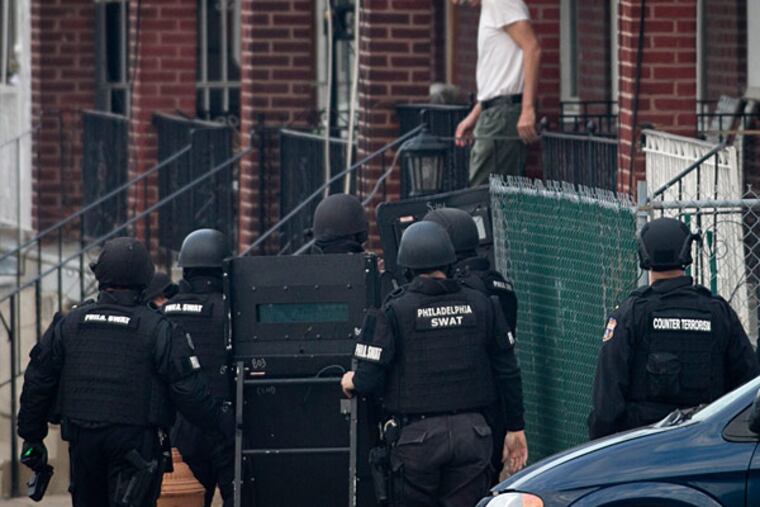 Philadelphia police, fire and SWAT were at the scene of a barricaded person in a row house near the intersection of E. Courtland near
Whitaker Ave on Wednesday, Dec. 4, 2013. A man walked out of the house shortly before 8 a.m. Wednesday morning. (ALEJANDRO A. ALVAREZ / STAFF PHOTOGRAPHER)