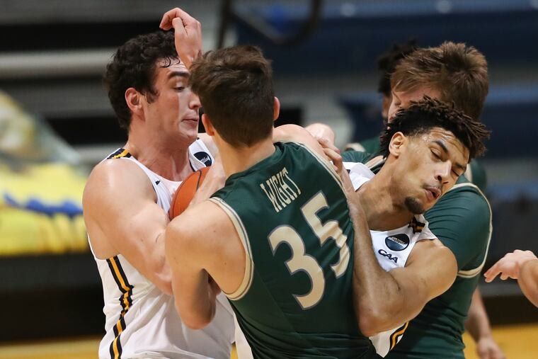Drexel players James Butler and T.J. Bickerstaff battle for a rebound with William & Mary forward Ben Wight (35) in the second half of a game at Drexel’s Daskalakis Athletic Center in Philadelphia last Saturday. The two teams will meet for a third consecutive time Saturday at William & Mary.