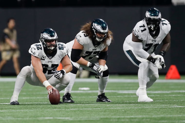 Eagles offensive linemen (from left) Jason Kelce, Isaac Seumalo and Jason Peters getting ready for a play in their Week 2 loss to Atlanta.