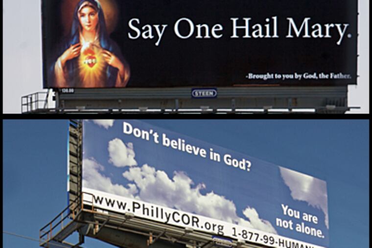 A billboard (top) that's been erected on I-95 with a photo of the Virgin Mary says: "Say One Hail Mary. - Brought to you by God, the Father." It replaces a billboard doubting God's existence.