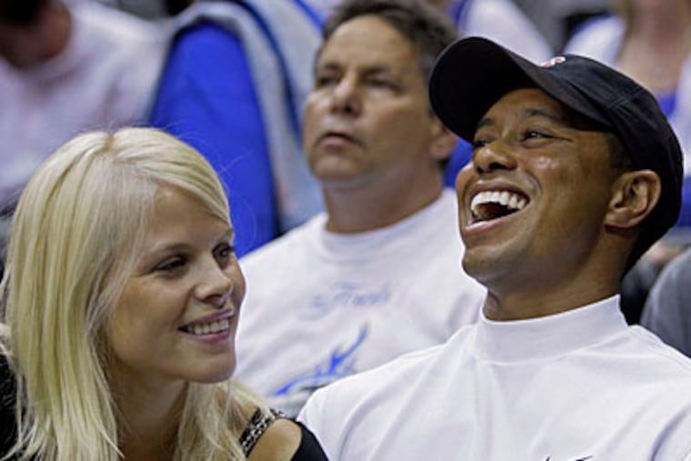 Elin Nordegren talks to her husband, golfer Tiger Woods, during Game 4 of the NBA basketball finals in Orlando, Fla. (AP Photo/David J. Phillip, File)