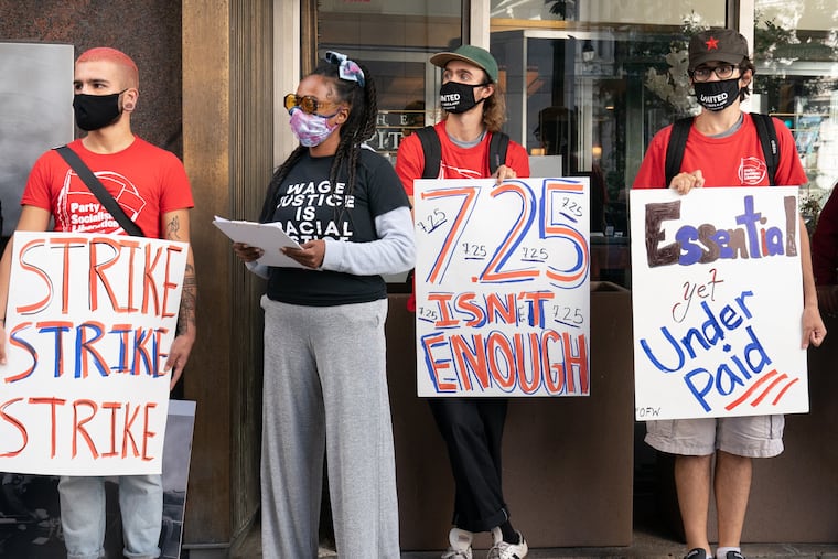 Restaurant workers in Philadelphia demonstrate at Broad and Chestnut Streets demanding a $15 minimum wage for all workers in the city in September 2020.