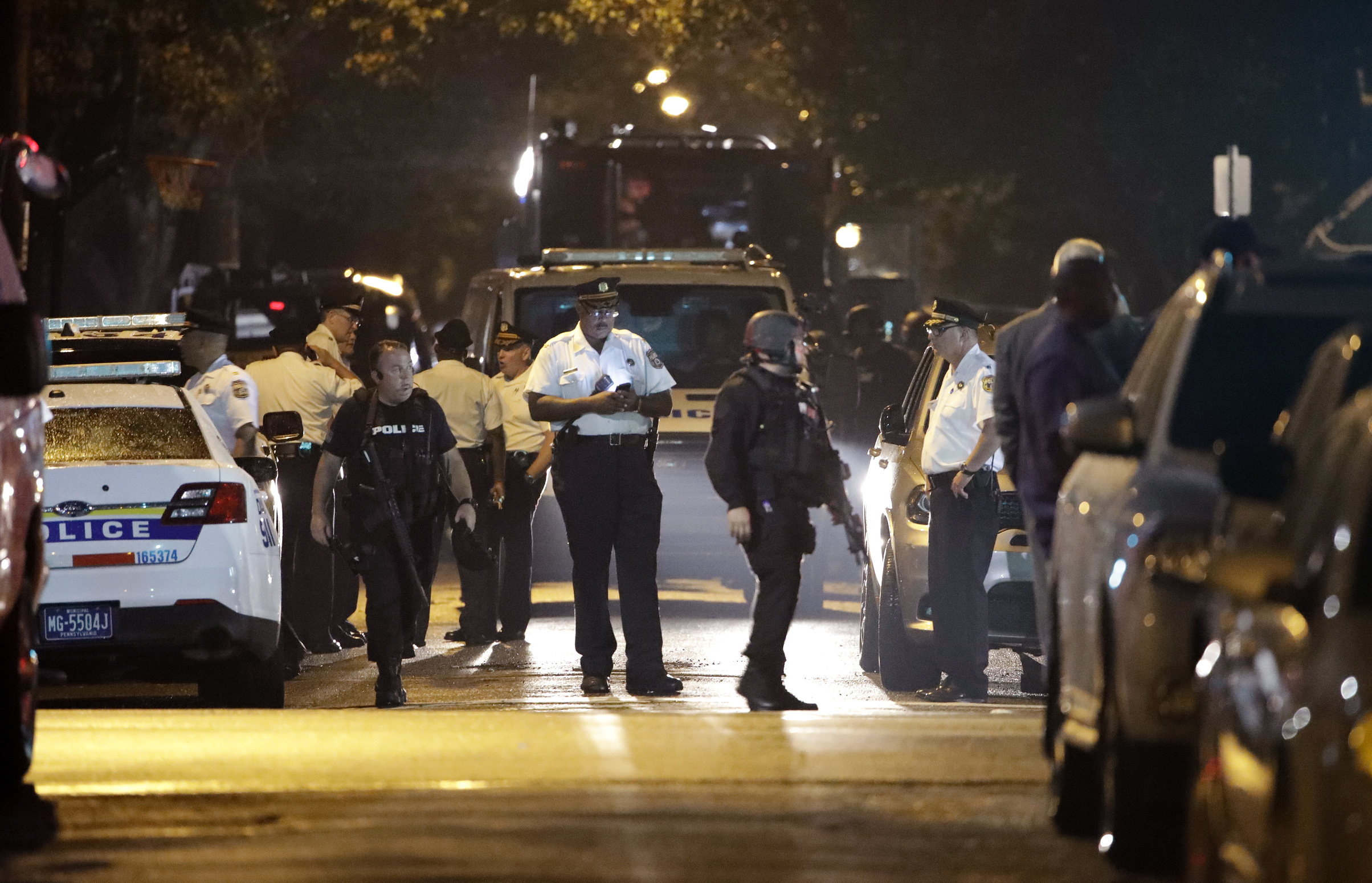 Police officers at the scene after a gunman was apprehended following a standoff in which he opened fire on officers serving a warrant in August 2019.
