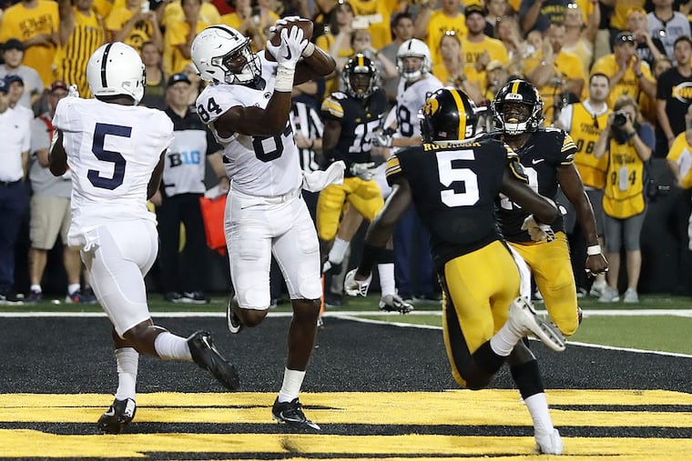 Penn State wide receiver Juwan Johnson (84) catches a touchdown pass between teammate DaeSean Hamilton, left, and Iowa defensive backs Manny Rugamba and Miles Taylor, right, as time expires in an NCAA college football game Saturday, Sept. 23, 2017, in Iowa City, Iowa.