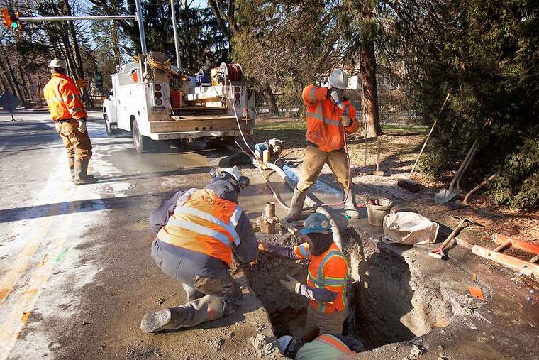 An Aqua Pennsylvania repair crew works on a ruptured water main in Merion Station.