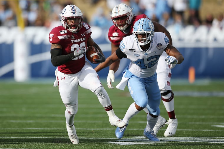 Temple running back Re'Mahn Davis runs past North Carolina linebacker Tyrone Hopper during the Military Bowl in December.
