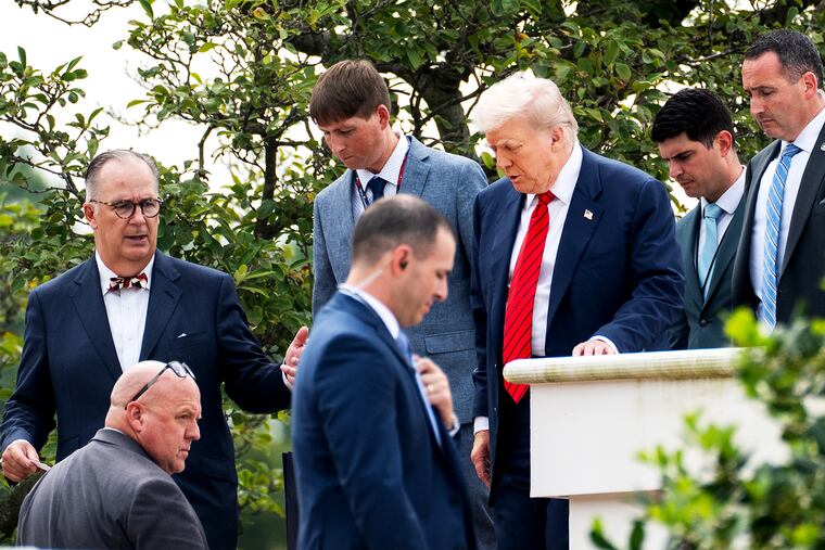 President Donald Trump and architect James McCrery II, far left, tour the roof of the White House on Aug. 5.