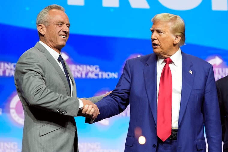 Donald Trump shakes hands with Robert F. Kennedy Jr. at a Turning Point Action campaign rally in October in Duluth, Ga.