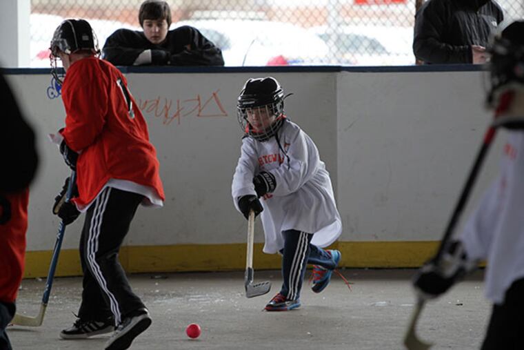 Bobby "Boo" Markley, 8, passes to a teammate during a youth hockey league match at the Fishtown Rec Center Rink in Philadelphia, Pa. on February 9, 2014. ( DAVID MAIALETTI / Staff Photographer )