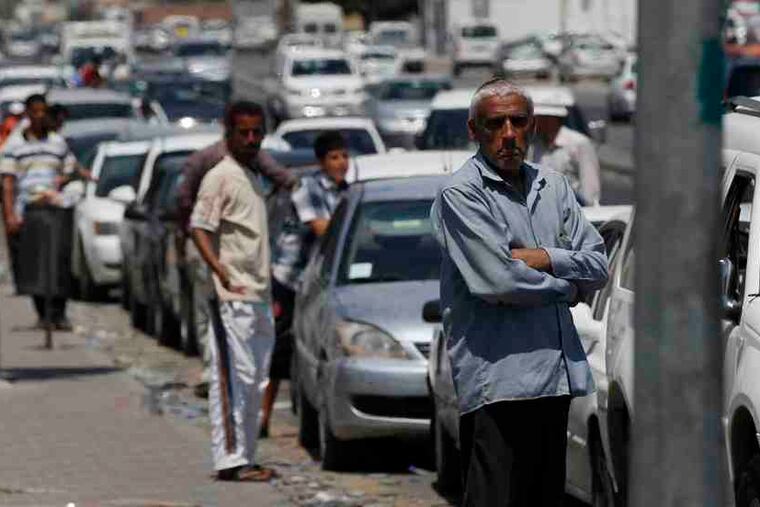 People wait in line at a gas station in Tripoli, Libya. Drivers have been known to wait two or three days in lines stretching miles. "Protest?" said a taxi driver when asked about pro-Gadhafi demonstrations. "People are too busy trying to get fuel."