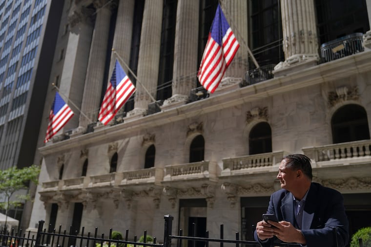 A trader stands outside the New York Stock Exchange in 2022 in New York.