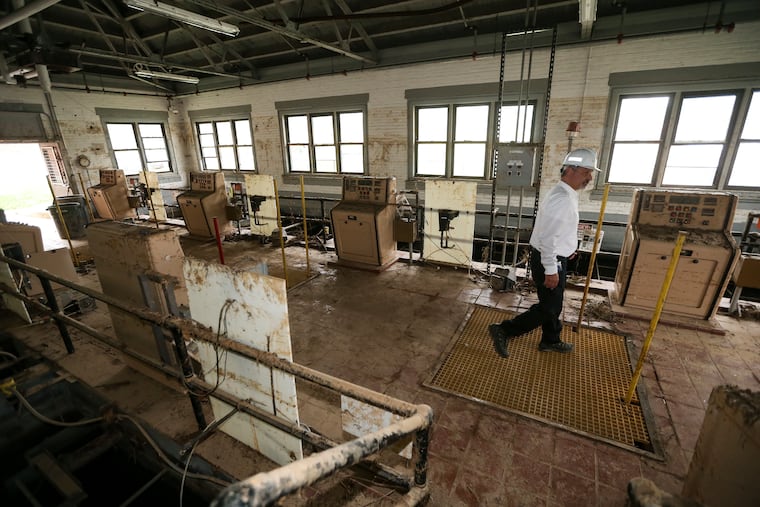 Marc Lucca, president of Aqua Pennsylvania, surveys flood damage in the original filtration building at the company's Pickering West water treatment plant near Phoenixville. Flooding after Tropical Storm Ida filled the building nearly to the tops of the windows, where a mud line remains visible. Aqua is reassessing whether to restore the building if operations at the flood-prone plant are relocated t higher ground.