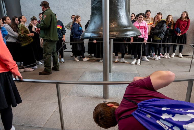 Ranger John Dunlap (left) talks with visitors at the Liberty Bell Thursday, Nov. 13, 2025 as the federal government returns to work after the longest shutdown in U.S. history. The Liberty Bell Center, closed since Oct. 1, reopened at noon.
