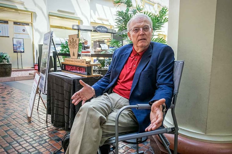 Barry Shutt sits in a lawn chair outside the statehouse cafeteria in Harrisburg.