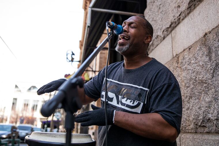 Jeremiah Thompson, a.k.a. "The Cunga Man," plays in his regular spot outside of Reading Terminal Market in 2022.
