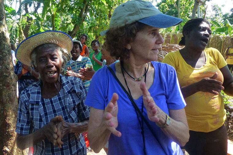 At one WIL meeting for the micro-finance institute Fonkoze in Haiti, WIL co-founder Linda Resnick ( right ) sings and dances with some of the women.