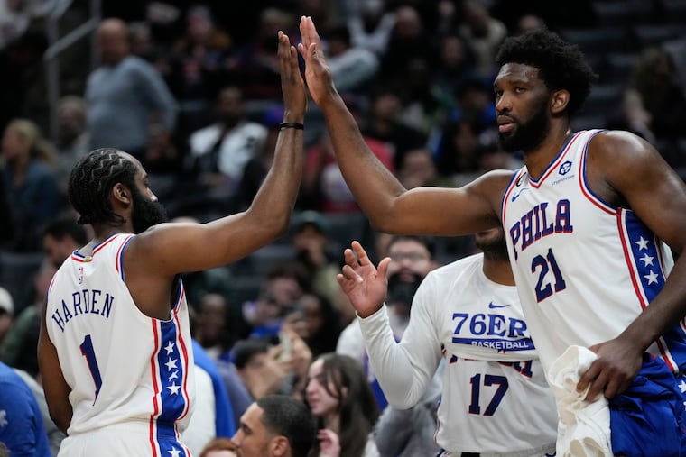 Sixers guard James Harden and center Joel Embiid high-five after returning to the bench during a game against the Los Angeles Clippers. Embiid had 41 points in the win.