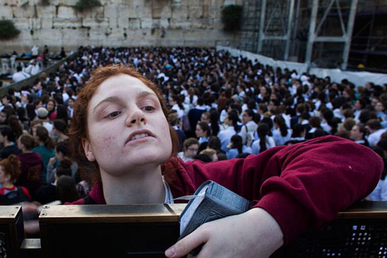 One of the women who went to the Western Wall to pray on Friday. A group that has been praying there monthly amid protests got police help this time. BERNAT ARMANGUE / AP