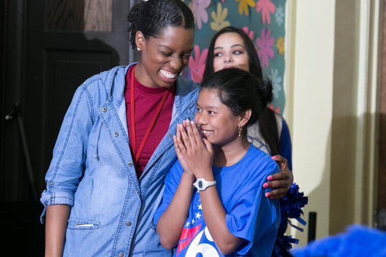 Seventh-grader Aye Aye with math teacher Melanie Young at Southwark Middle School pep rally.