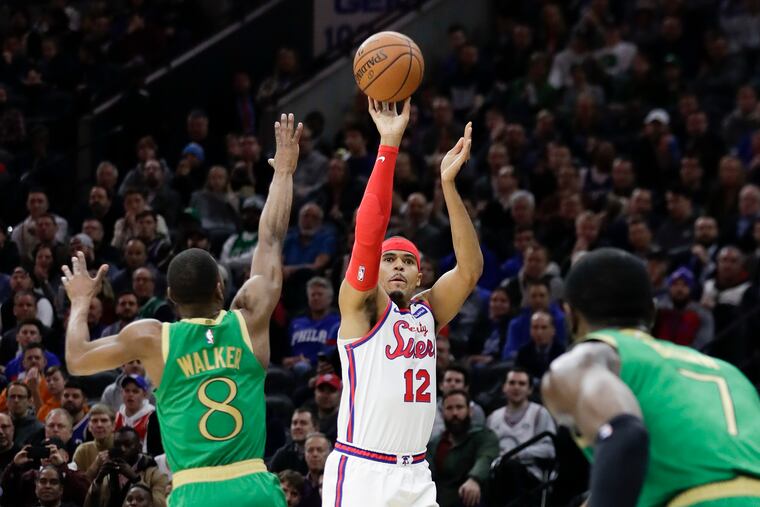 Sixers forward Tobias Harris shooting against Celtics Kemba Walker (left) and Jaylen Brown.