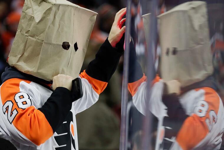 A Flyers fan wears bag over his face during second-period action against the Carolina Hurricanes on Thursday, January 3, 2019 in Philadelphia.