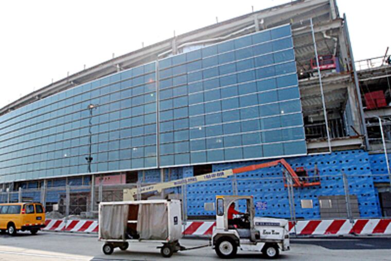 The glass facade of the new area between terminals D and E as seen from the airplane side of the terminals. (Michael Bryant / Inquirer)