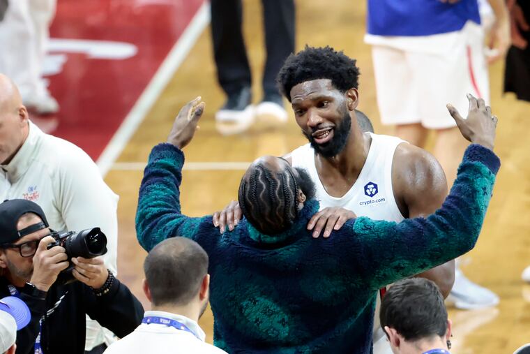 Joel Embiid is embraced by James Harden after Embiid scored 59 points in a win over the Utah Jazz on Sunday.