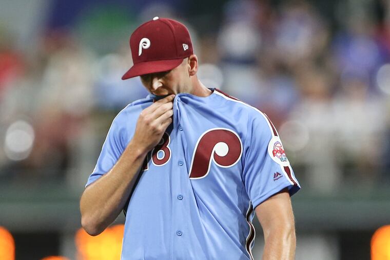Phillies pitcher Drew Smyly wiping his face after allowing a run earlier this month.