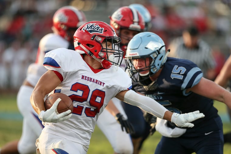 R.J, Macnamara (right, No. 15) closing on Neshaminy running back Chris James in Friday night's season opener.