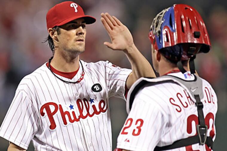 Cole Hamels celebrates with Brian Schneider after wrapping up a complete-game win. (Steven M. Falk/Staff Photographer)